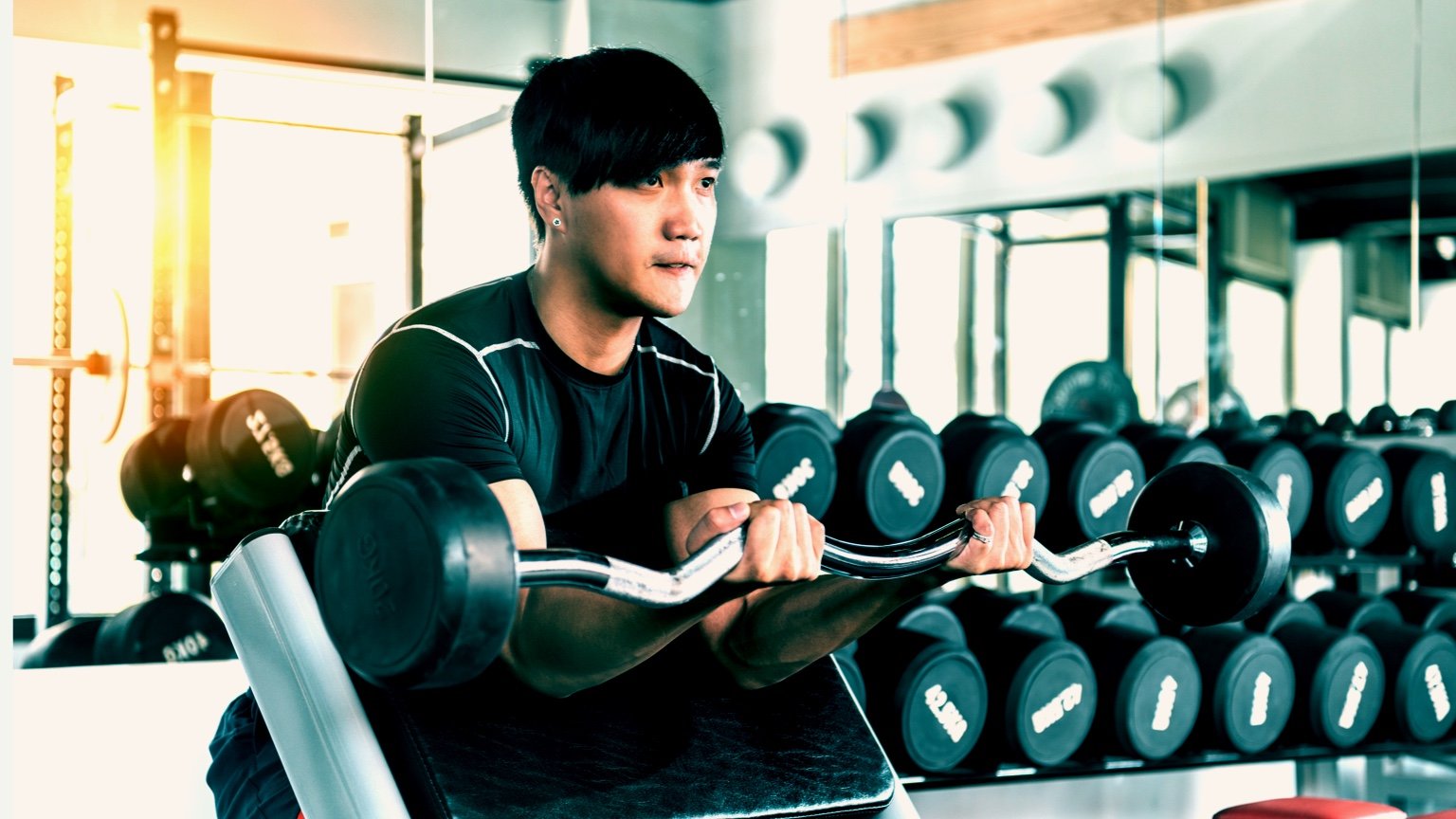 Man performs preacher curls