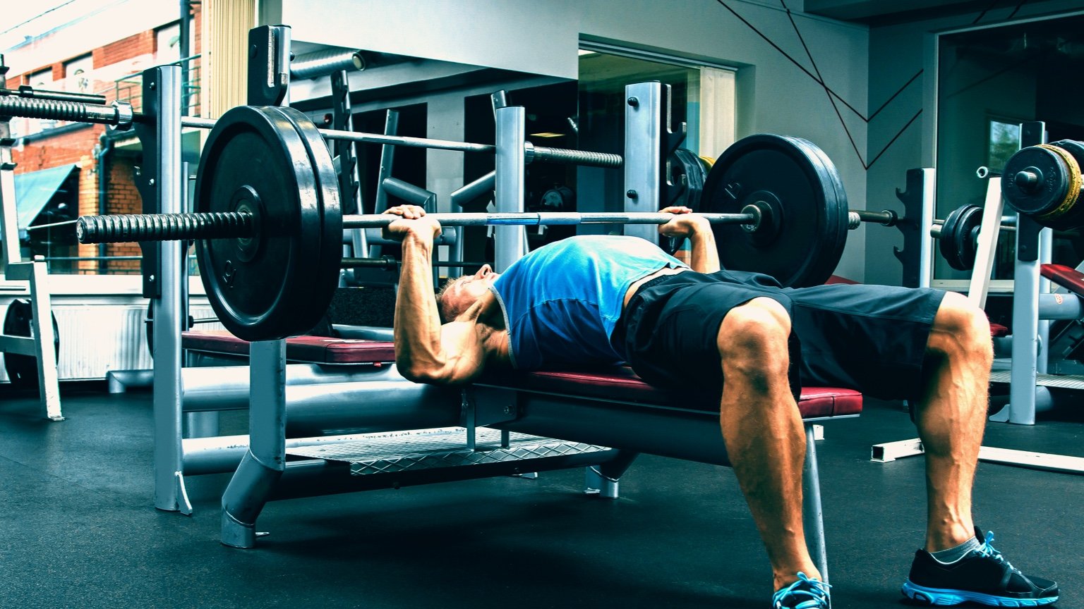 Man performs bench press