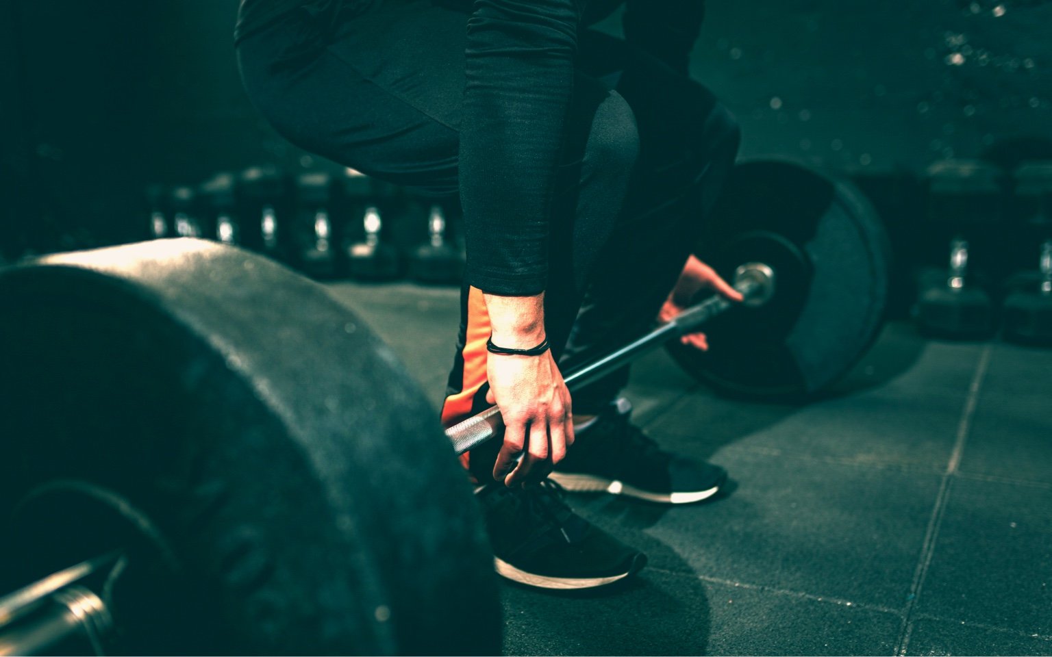 Man picks up a barbell using a mixed grip