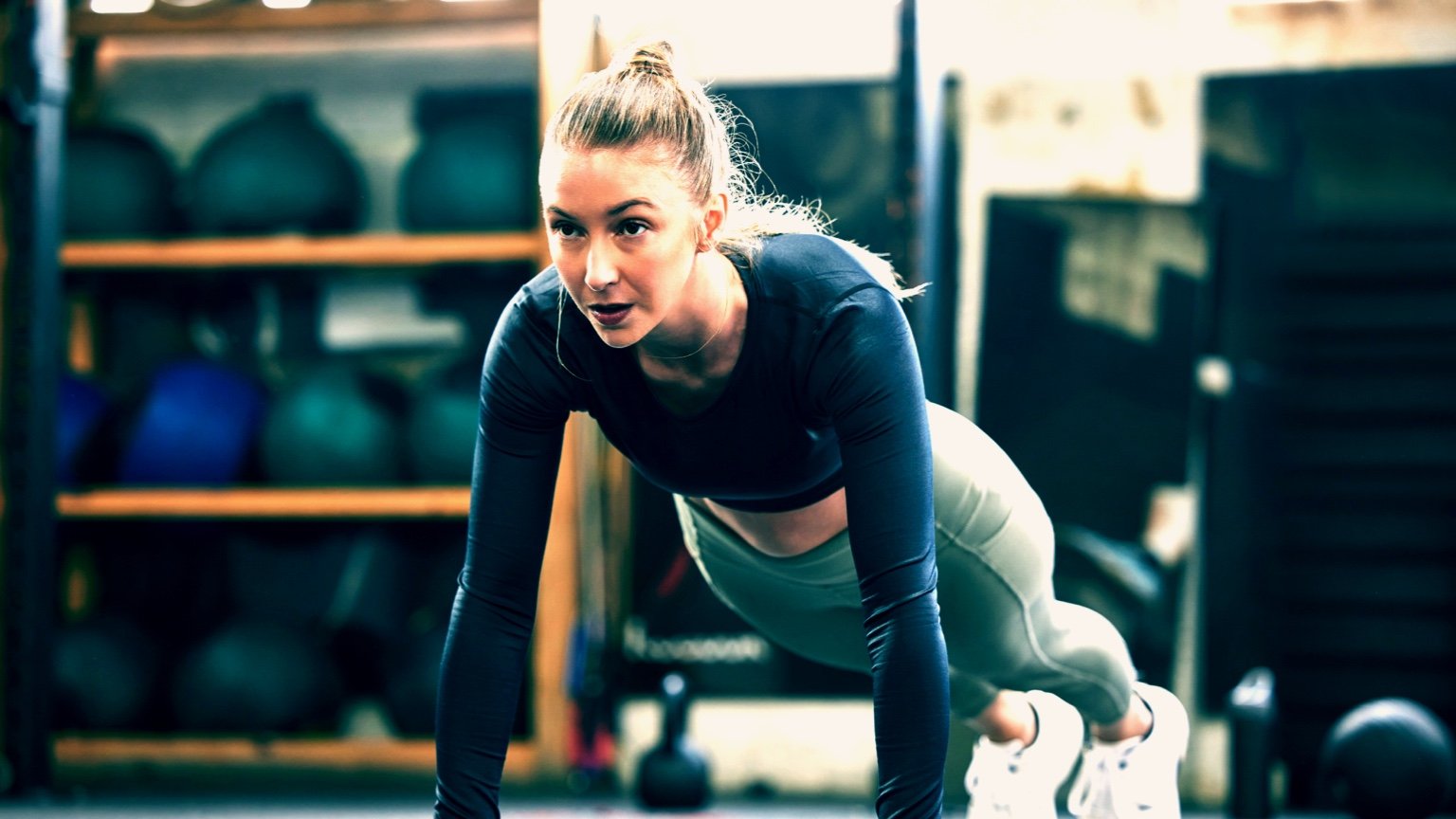 Girl performs a push up as part of her workout routine