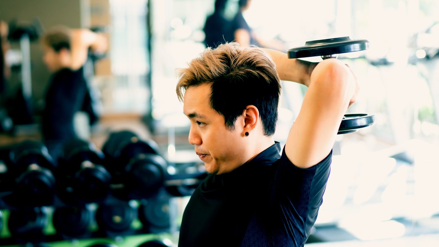 Man performs an overhead tricep extension