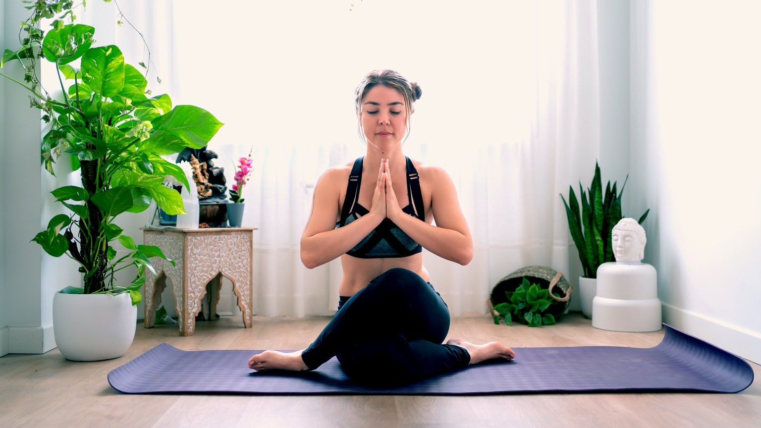 Girl performs a yoga pose at home