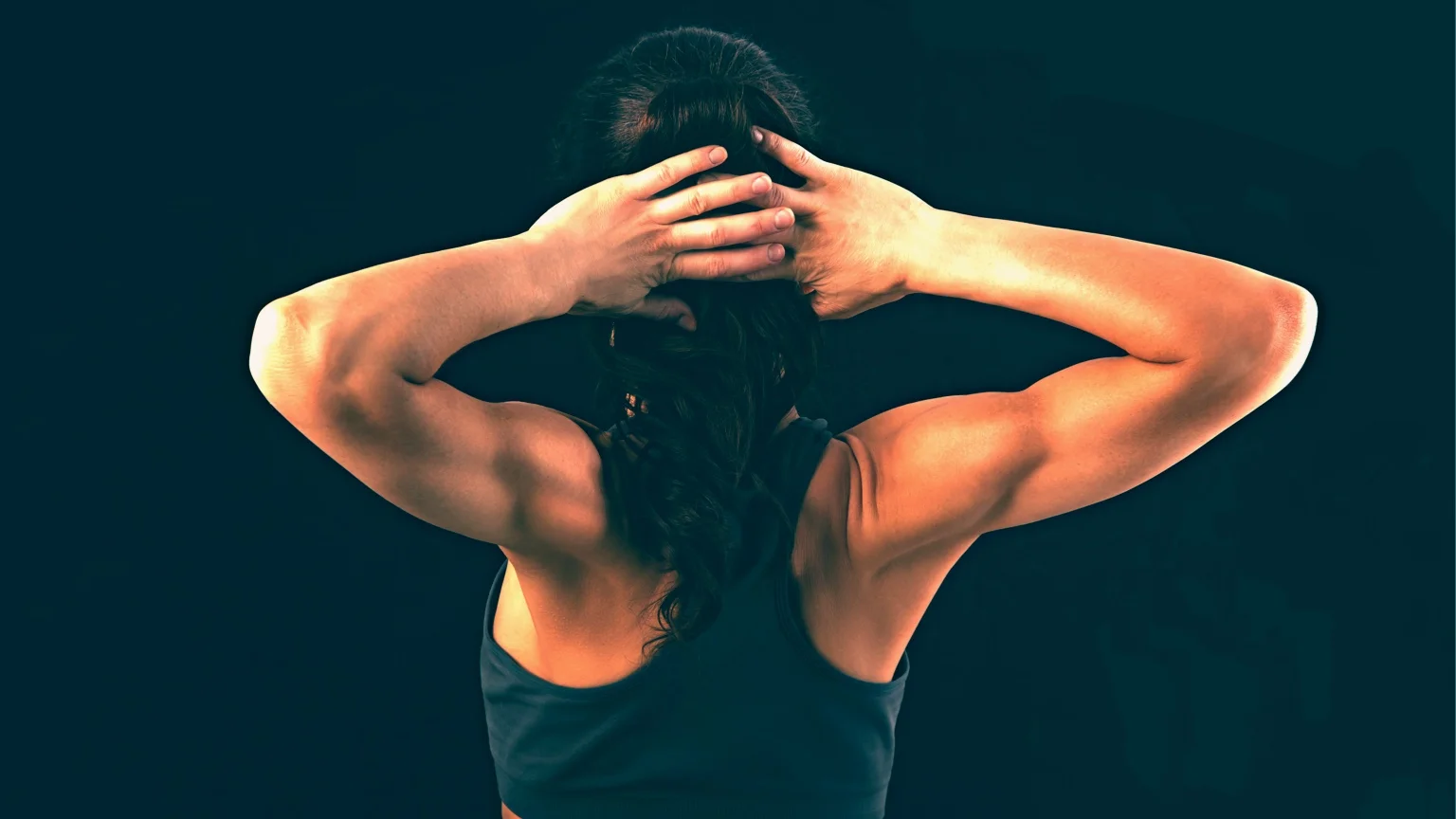 Woman squeezes her shoulder blades, performing exercises to strengthen rhomboids.