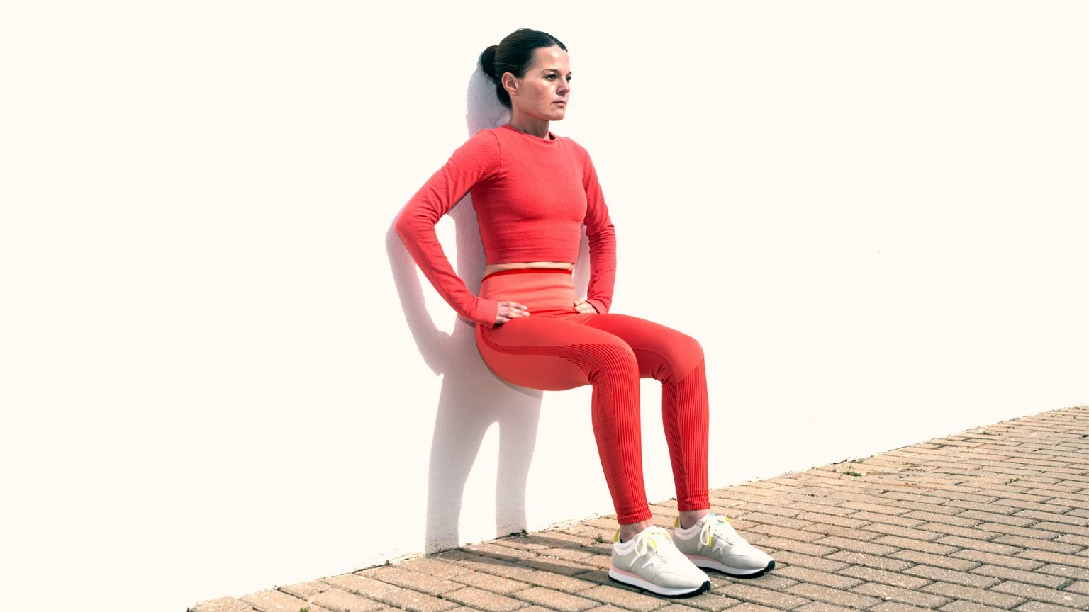 photo - Athletic woman performs a wall sit