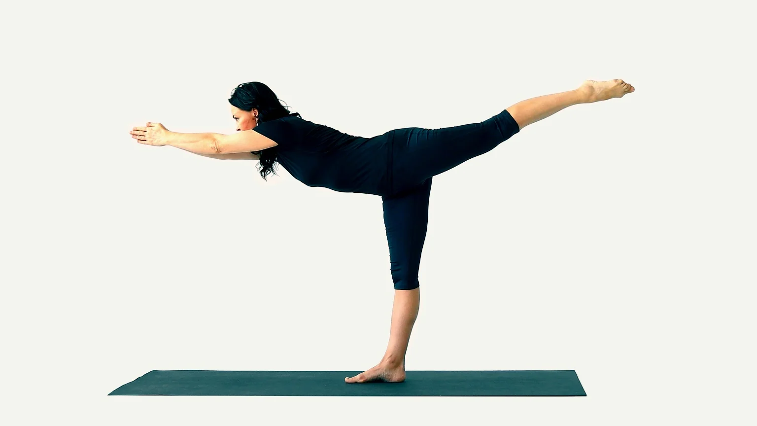 A woman performs the Warrior 3 pose