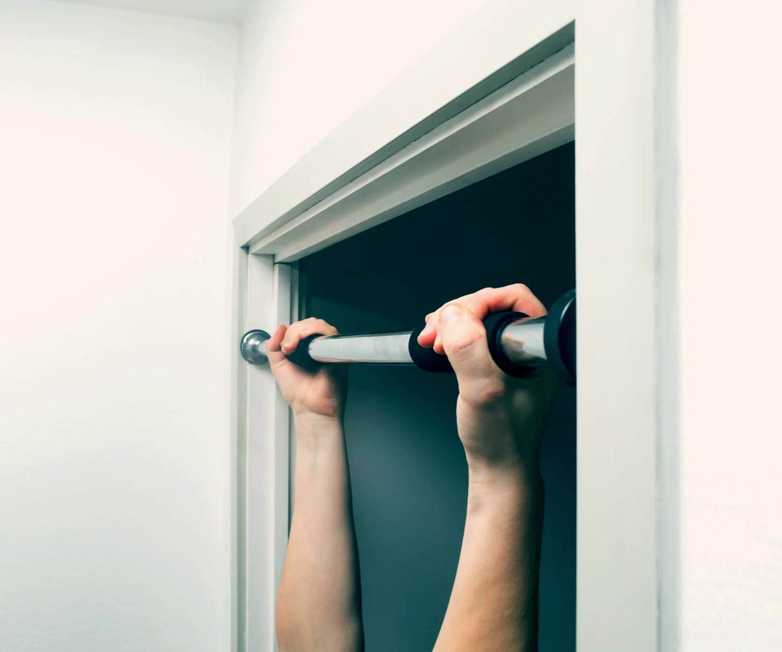 photo - Door frame with a pull-up bar attached.