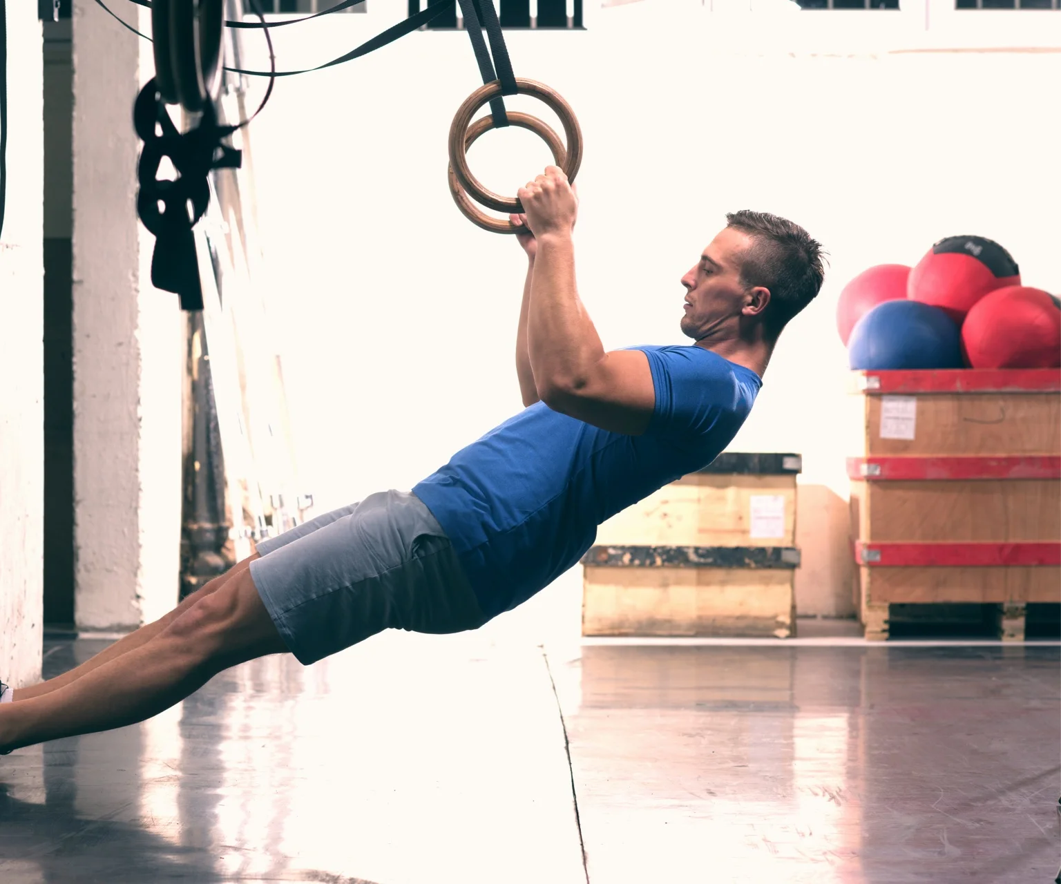photo - Man performs TRX inverted rows
