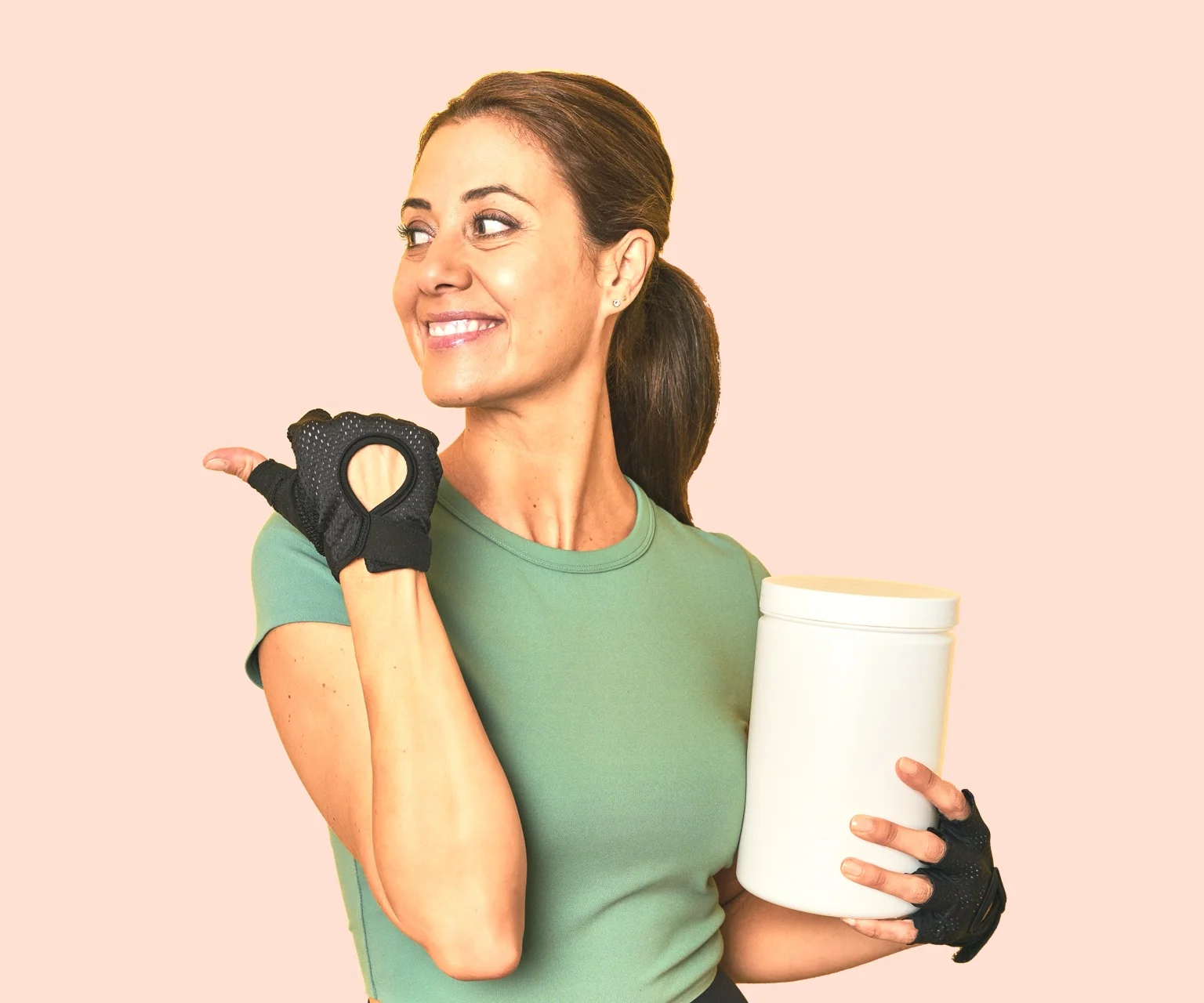 photo - Woman poses holding a tub of protein powder