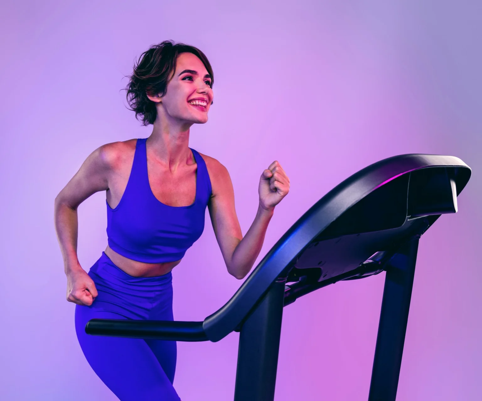 photo - Woman runs on a treadmill. The treadmill is a common cardio exercise at the gym.